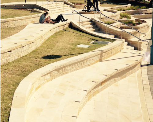 sandstone paving, steps with curved walls and split faced capping.