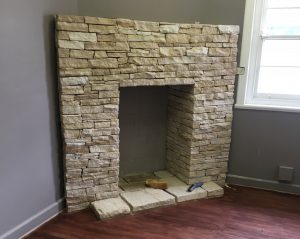 sandstone flagging laid as stack stone fireplace