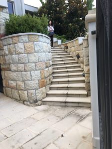 Bull-nosed stone step treads and risers laid curved.