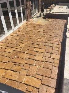 Australian random sandstone flagging in a random square pattern bieng laid