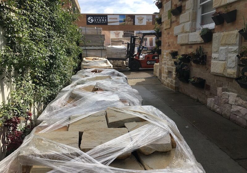 Flagging pallets at yard 800pix Sandstone flagging pallets in a mix of colours.