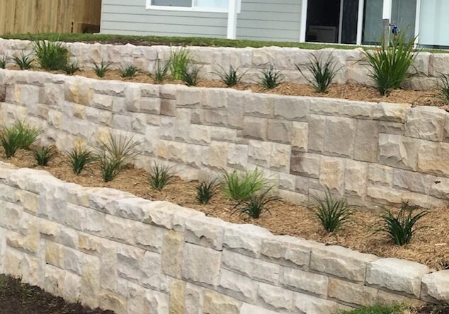 ballsat cut to random square with tight joins. sandstone ballast blocks cut into a tight join dry pack wall.