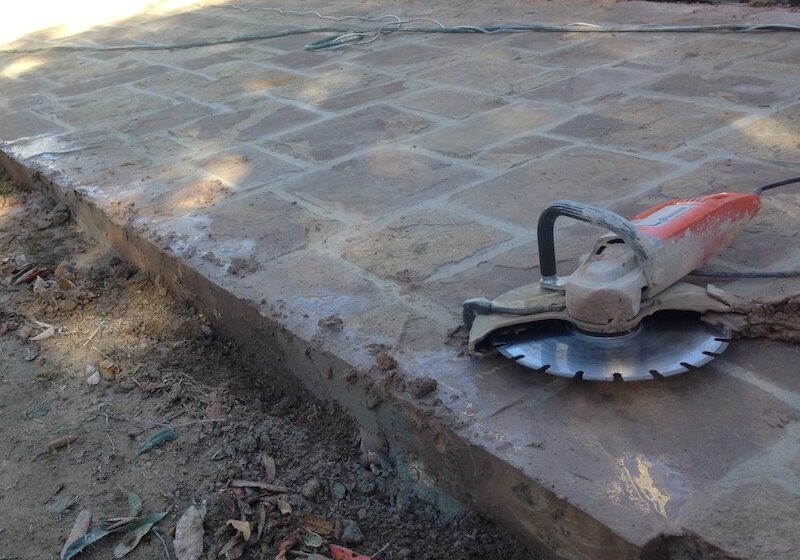 flagging random square bieng cut driveway 800pix Australian Flagging;Thick Sandstone Driveway paving being cut.